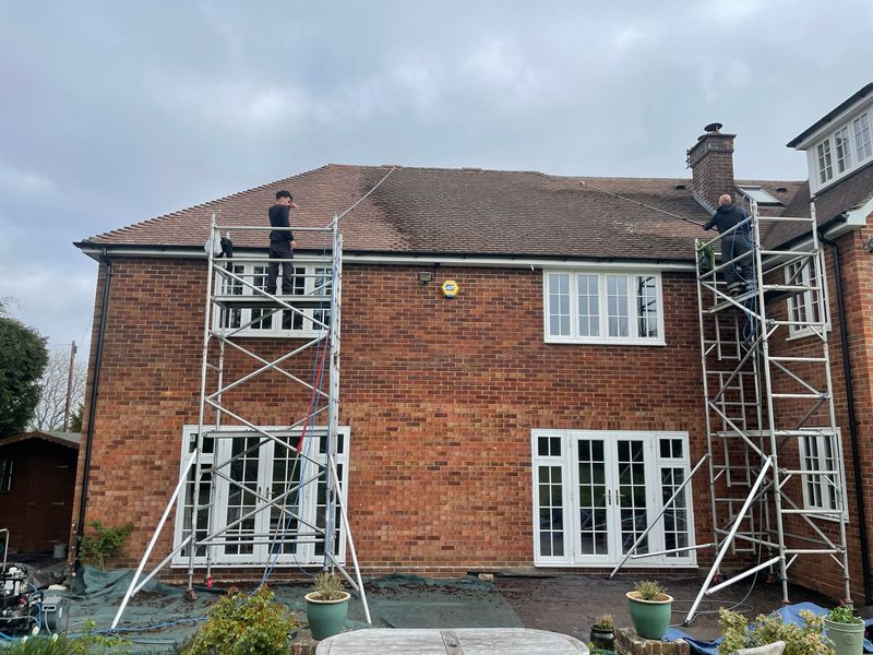 Roof cleaning carried out safely from scaffold towers by The Roof Moss Cleaners in Henfield